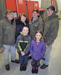 The Boettchers installed four robots on their 230-cow farm near Wykoff, Minn. Pictured (back row, from left) Curtis, Cheryle, Brian and Chad; (front) Curtis and Cheryle’s grandchildren, William and Kayla Arndorfer. PHOTO BY KRISTA KUZMA