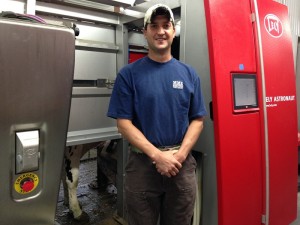 Nate Tullar next to milking robot