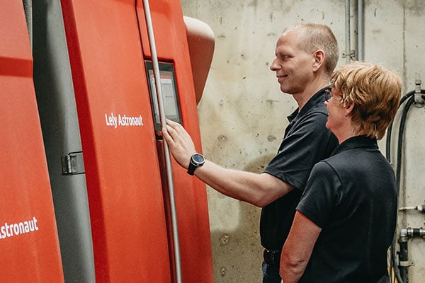 Anton Borst and his wife looking at data on the Lely Astronaut A5 robotic milking system