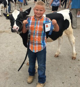 Riley Siemen with his prize winning dairy cow