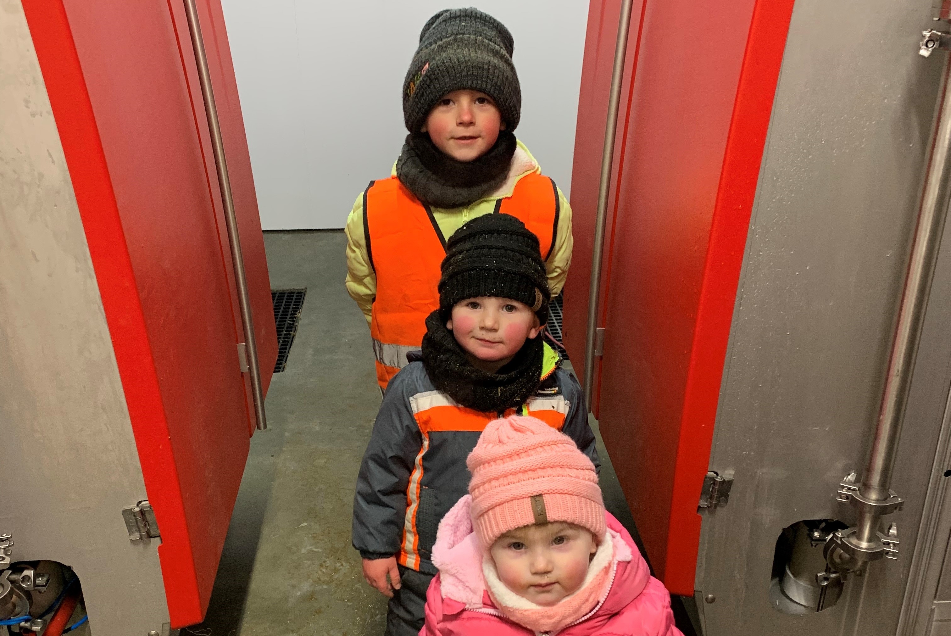 Keilen kids inside robot room with Lely Astronaut A5 robotic milking system