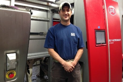 Nate Tullar near robotic milker