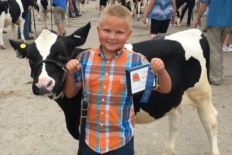 Riley Siemen with his award winning dairy cow.