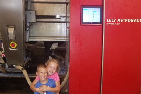 Maggie and Max of Wolff Farms with their family's Lely Astronaut A4 automatic milking system.